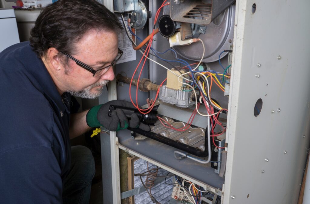 furnace 9 technician repairing furnce unit