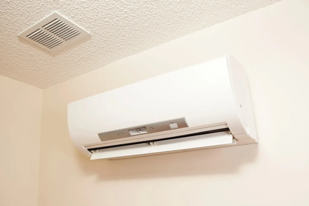 ductlessac a white daikin ductless mini-split indoor air conditioning unit is mounted on a light-colored wall.