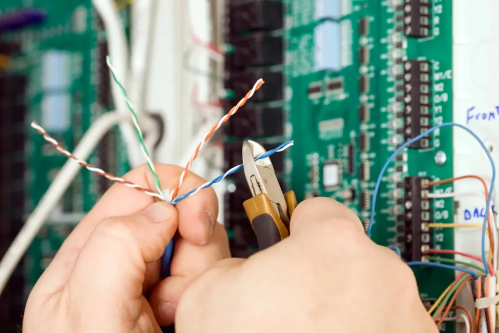 electricalinstallation technician arranging wires with a tool