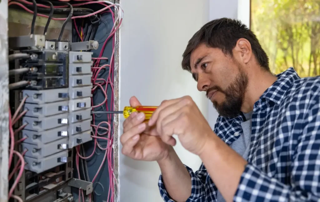 electricalwiringrepair man repairing a electrical service in electrical panel