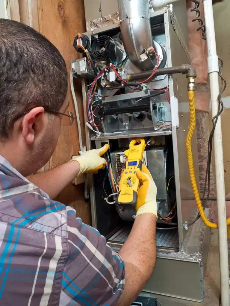 furnacerepair2 a man repairing a furnace with tools