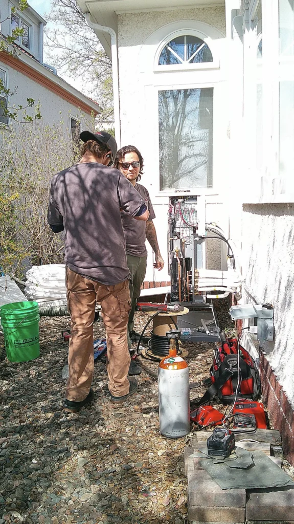 technicians working on condenser 1 1 heat pump